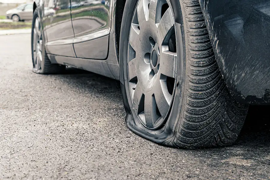 Dark car in Decatur, IL suffering from more than one flat tire.