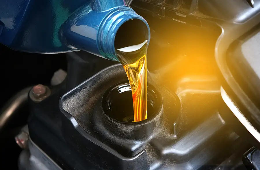 Regularly Scheduled Maintenance services - close up view of car getting an oil change, routine maintenance - Decatur, IL