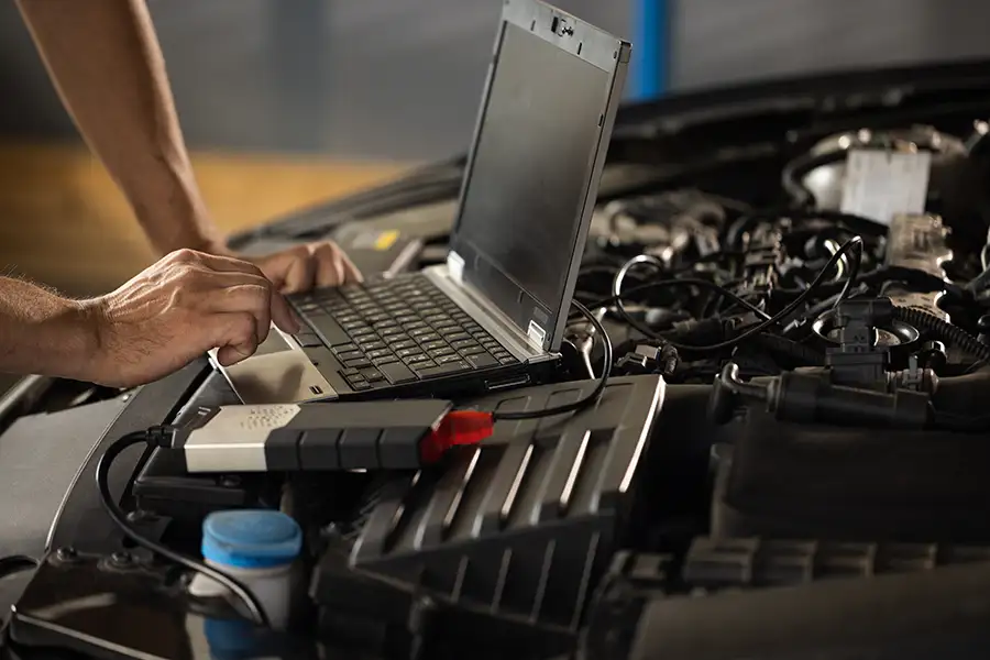 professional mechanic performing engine diagnostics with computer, check engine light diagnosis - Decatur, IL