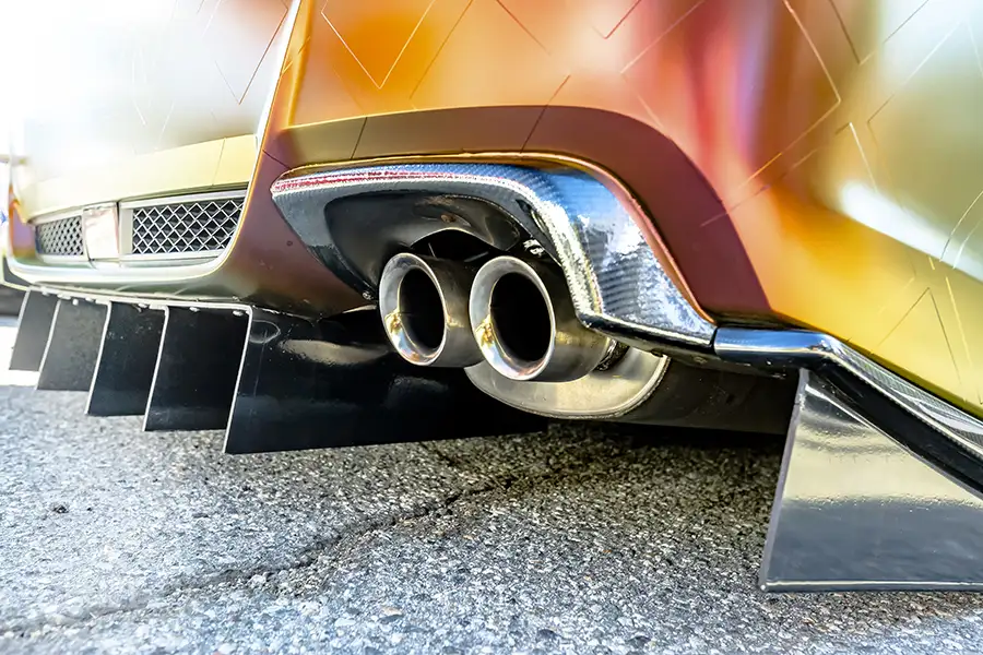 Car Repair Shop, Custom Exhaust Systems - close up on muscle car's tail pipe and muffler system - Decatur, IL