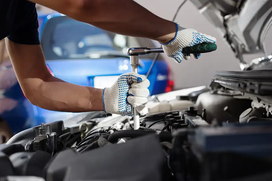 Auto Repair Services, professional mechanic performing an engine tune-up on standard car - Forsyth, IL